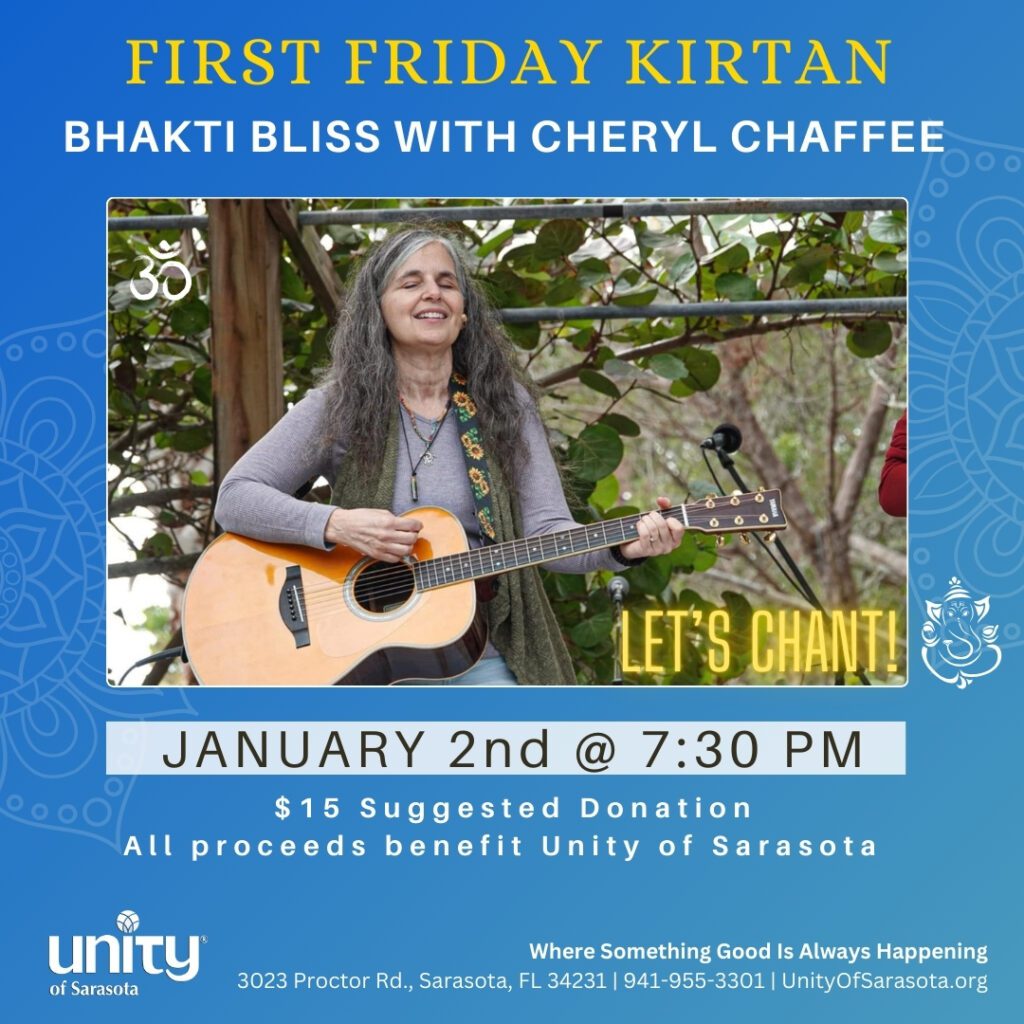 Woman playing guitar at a kirtan event.